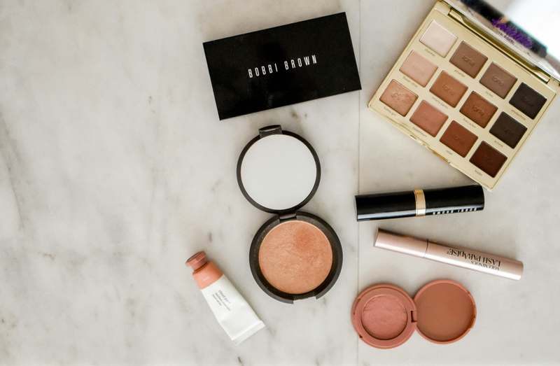 Stylish vanity with organized makeup stand holding brushes, compacts, and skincare bottles